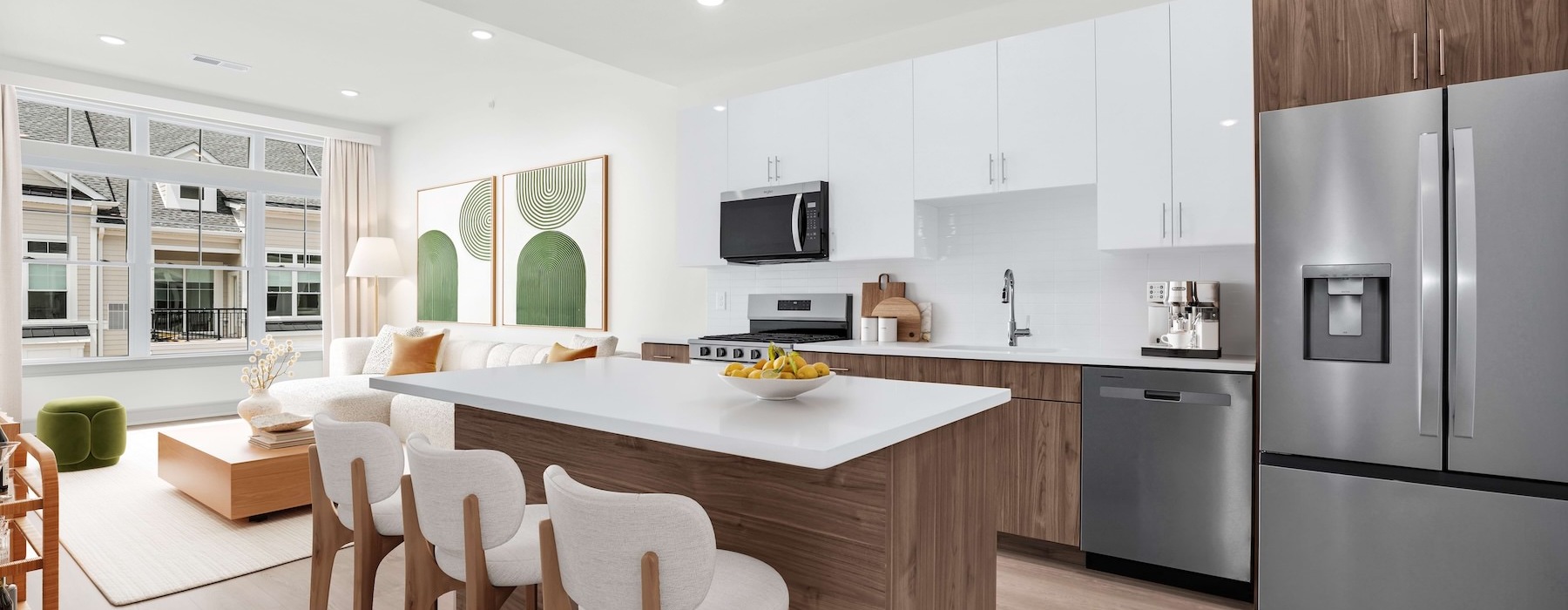 Large apartment  kitchen with island, bar stools and living room