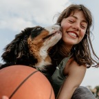 girl playing basketball with dog